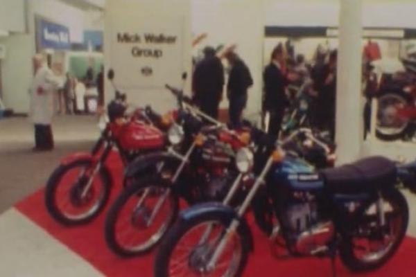Image of a line of motorbikes on display at a trade show.