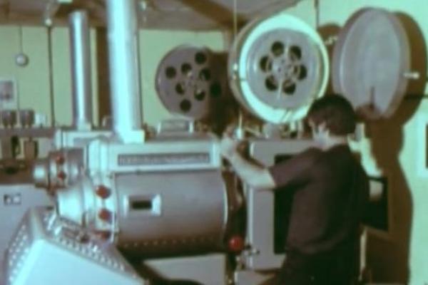 Image of a projectionist and projector.