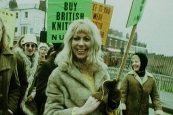 Image of a textile rally, along with placards and slogans.