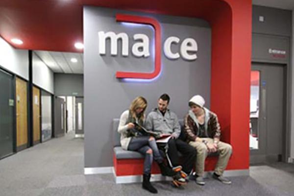 Image of Students sitting outside the MACE office.